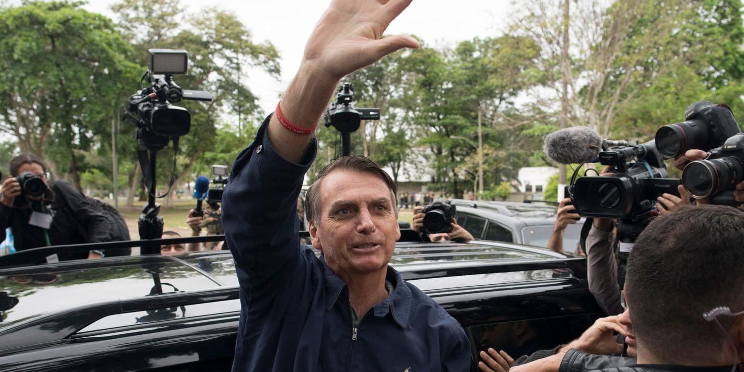 Favoriten i söndagens presidentval i Brasilien, starkt högerinriktade Jair Bolsonaro från Socialliberala partiet (PSL), vinkar till sina anhängare efter att ha röstat i Rio de Janeiro.