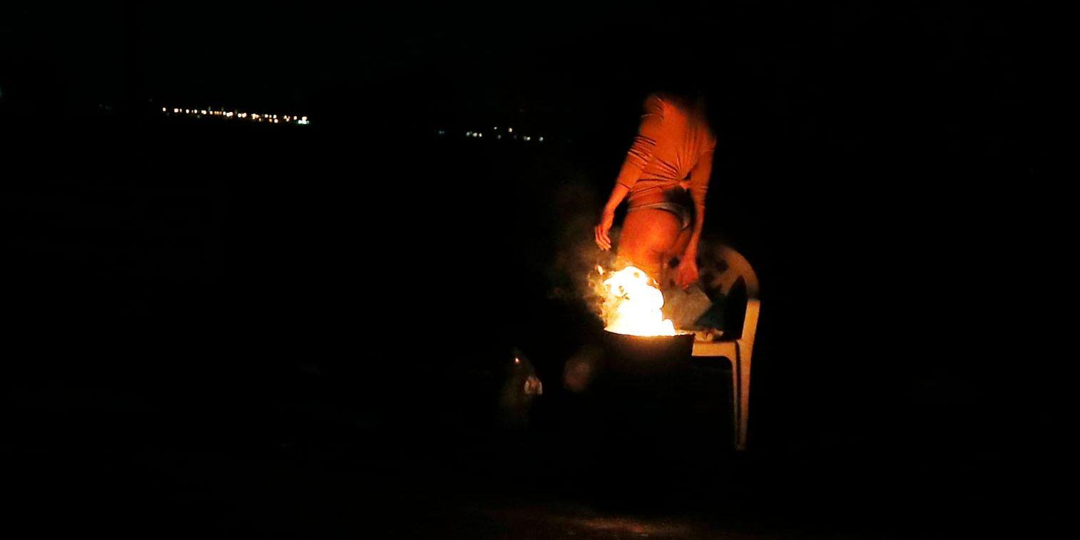 En prostituerad kvinna vid en eld längs med en italiensk väg. Många migranter exploateras som sexarbetare i landet. Arkivbild