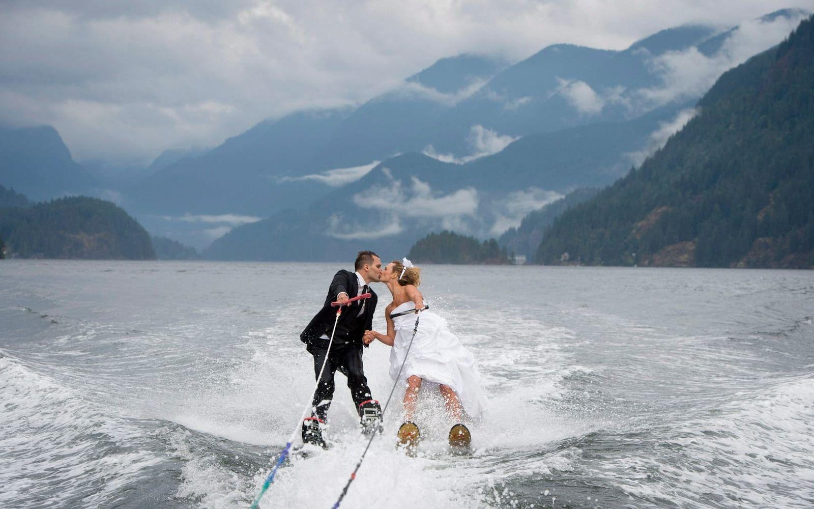 Även ovanför ytan fungerar det utmärkt att gifta sig. Cam Auge och Caylee Wasilenko från Vancouver åkte vattenskidor i samband med bröllopet.
Själva ceremonin skedde på land i Vancouver Waterski Clus område, men paret avslutade med att ta den traditionella kyssen ute på vattnet. Bild: TT
