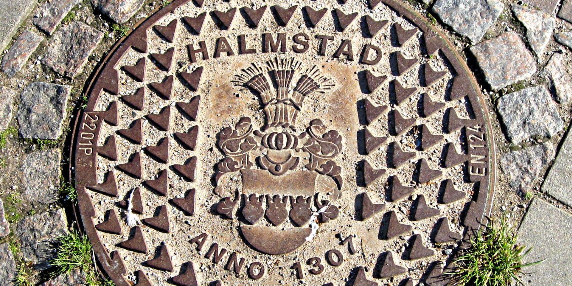 Till Halmstads 700-årsjubileum tog kommunen fram detta gatubrunnslock. Halmstad är tillsammans med Malmö den enda stad som har ett komplett vapen med hjälm, hjälmprydnad, hjälmtäcke, klenlod och sköld.