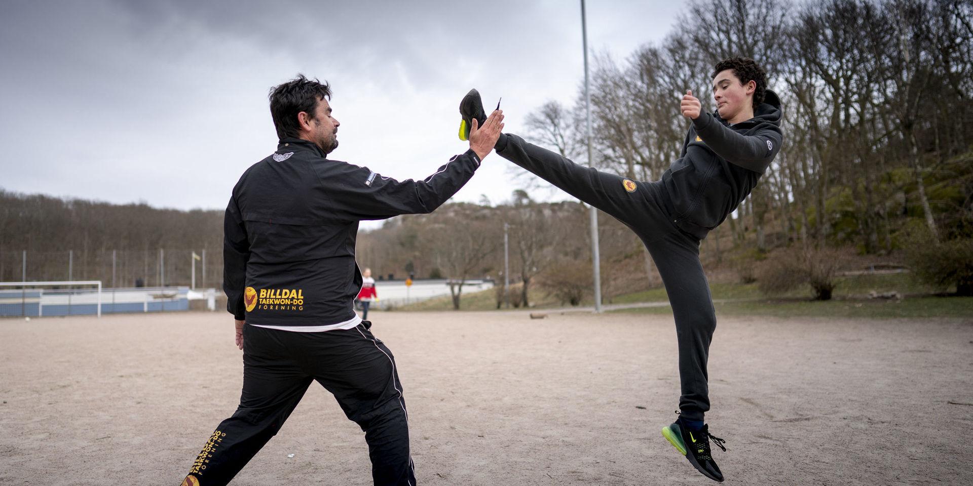Mathias Hansson och sonen David Hansson Bärring i Billdal Taekwondo tränar utomhus på en grusplan då den vanliga träningen är stängd på grund av coronaviruset.