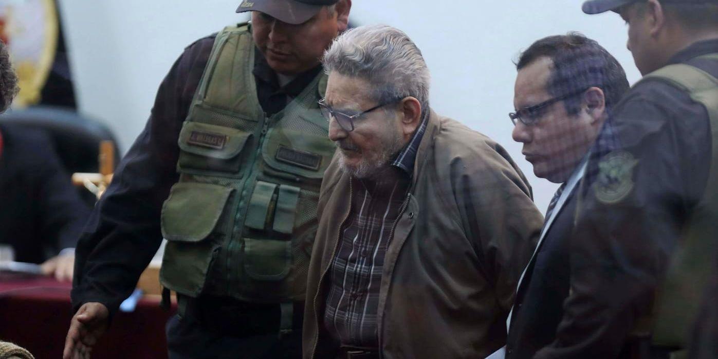 Abimael Guzmán, grundare av maoistgerillan Sendero Luminoso, anländer till rätten vid en militärbas i Callao utanför Perus huvudstad Lima på tisdagen.