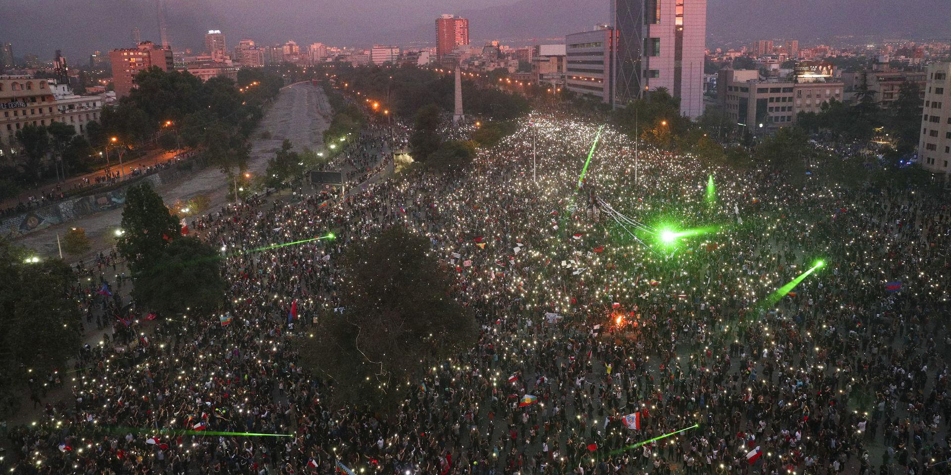 Tiotusentals demonstranter samlades vid Plaza Italia i Santiago på fredagskvällen. 