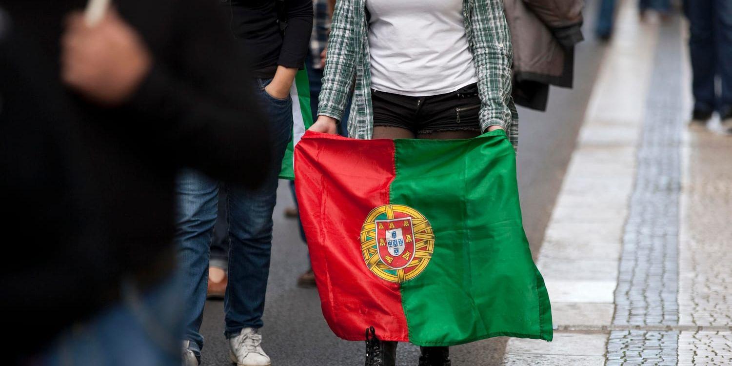 Flyr landet. Många portugiser söker ett bättre liv i ex-kolonierna efter finanskrisen. Här syns en kvinna i Lissabon under en protest mot nedskärningar av löner och pensioner. Arkivbild.